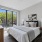 Bedroom with a dresser and large windows