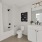 Bathroom with a white vanity and large mirror