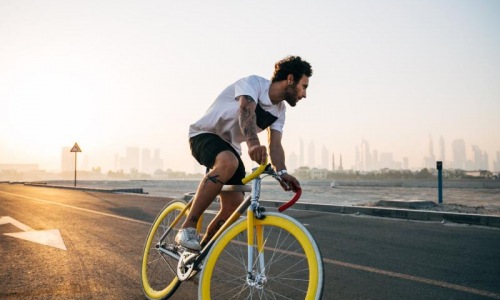 a man riding a bicycle on a road