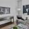 Living room with seating options and a wall mounted tv