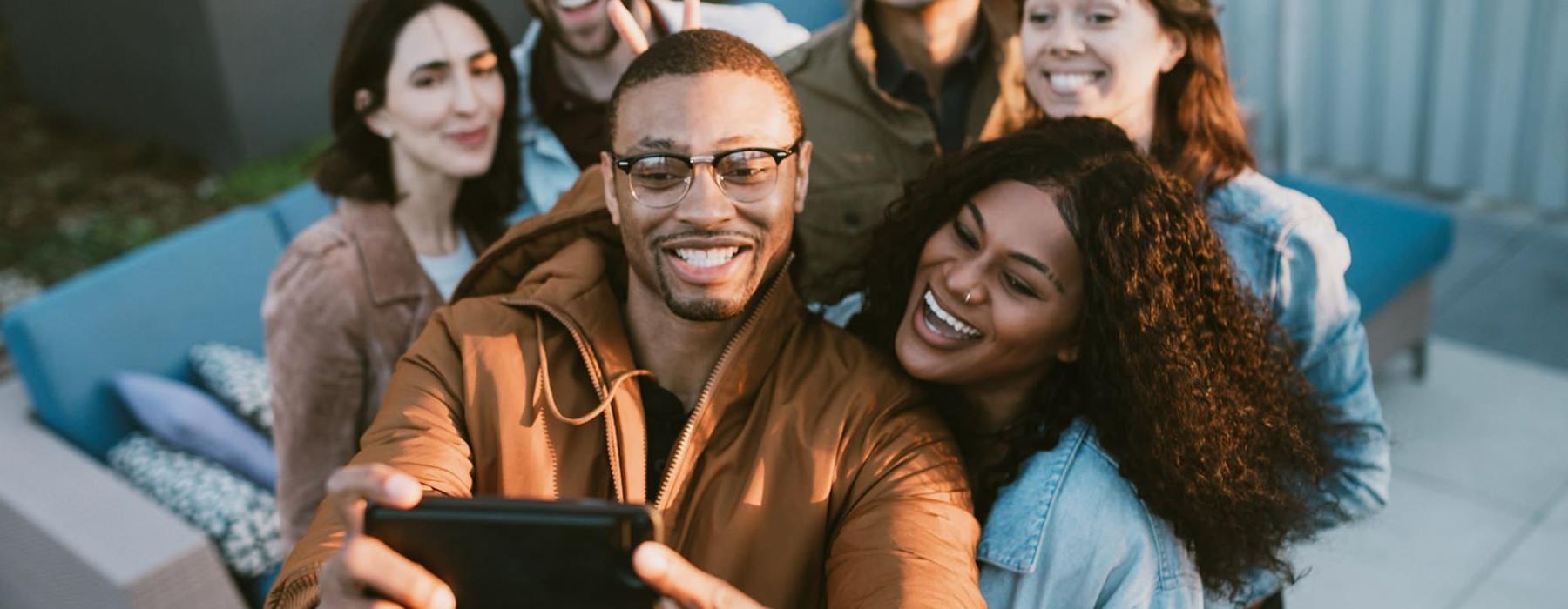 friends take a group selfie outdoors