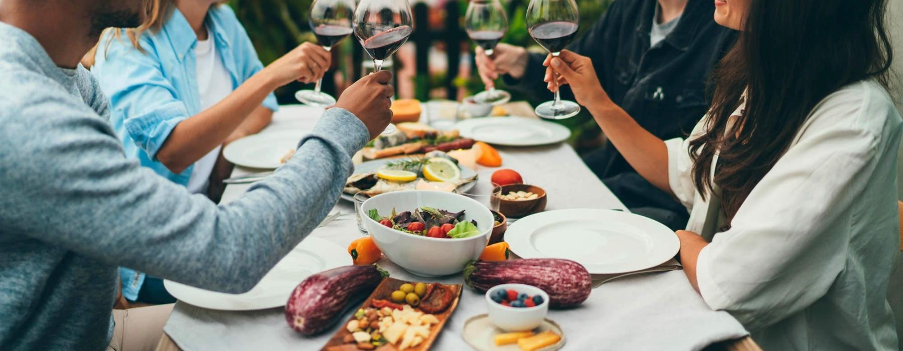 a group of people having a meal around an outdoor table